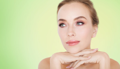 Naklejka premium beautiful young woman face and hands