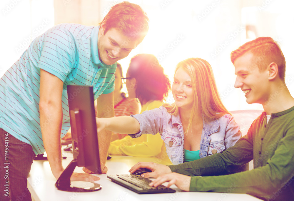 Wall mural smiling students in computer class at school