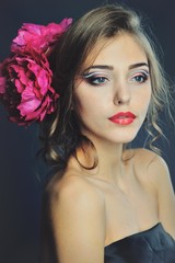 Spring model with flowers in her hair and fashion makeup . Summer girl with trendy make up and hairstyle .