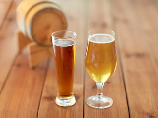 close up of different beers in glasses on table