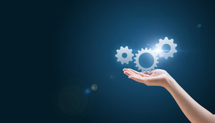 hand hold gear on a blue background