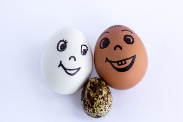 Funny eggs imitating a happy mixed couple with multicolored baby