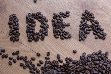 Idea concept sign drawn among brown roasted beans  of coffee