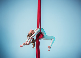 Graceful gymnast performing aerial exercise