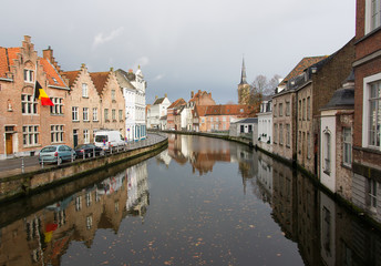 Fototapeta na wymiar The view of the canals and the historic quarter of Bruges cloudy autumn morning. Bruges is one of the oldest and most beautiful cities in Europe