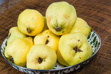 Yellow quince on wooden table