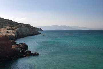 The sea of different colors of blue surrounded by mountains