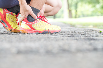 Fototapeta na wymiar Sports injury. Pain in ankle while jogging