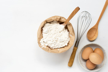eggs and flour on white table background. basic baking background.
