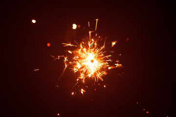 Christmas sparkler in haze with red light