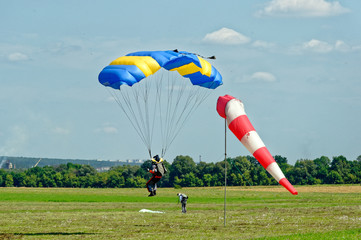 Paraglider landed after the jump at a bright sunny summer day. Active lifestyle, extreme hobbies
