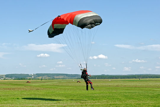 Paraglider landed after the jump at a bright sunny summer day. Active lifestyle, extreme hobbies