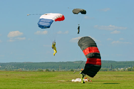 Paraglider landed after the jump at a bright sunny summer day. Active lifestyle, extreme hobbies