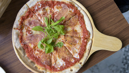 Pizza in wooden tray, Top view