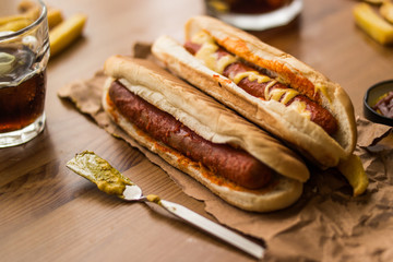 Hot Dog Sandwich with Yellow Mustard, Beverage and Potatoes.