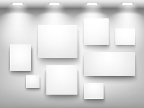 Gallery of empty frames on wall with lighting