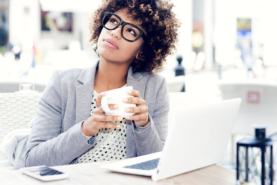 Elegant African American Woman Drinking Coffee, Working.