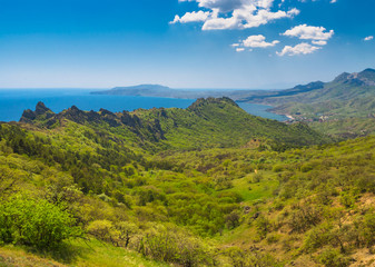 Fototapeta na wymiar Spring view from Karadag volcanic mountain range to Meganom cape on a Black Sea shore, Crimean peninsula