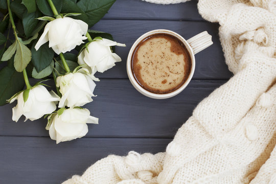 Cup of black coffee with milk or cream, white knitted plaid and