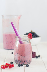 Blueberry smoothie on the white wooden background