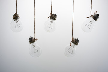five incandescent light bulbs on a white background
