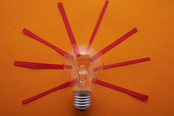 incandescent bulbs with red rays on a yellow background