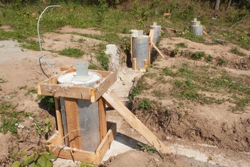 Building site. Foundations of a house. Concrete foundations of the house. Construction of a small...