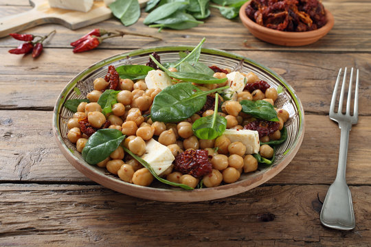 ceci insalata con pomodori secchi spinaci e formaggio sfondo tavolo di cucina rustico