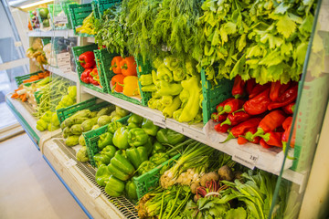 vegetable counter at the grocery store European supermarket, Mall with peppers, herbs, onion and parsley