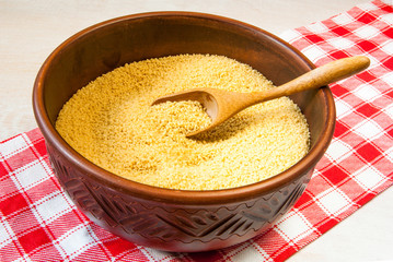 Raw couscous in rustic plate