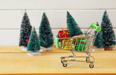 Shopping cart with christmas tree and presents