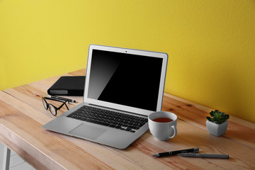 Fototapeta premium Working place on yellow wall background
