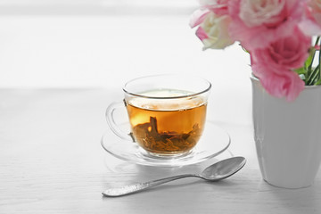 Cup of tea with flowers on table