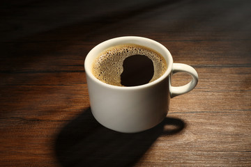 Cup of coffee wooden background