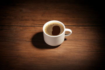 Cup of coffee wooden background