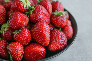 Fresh strawberries in plate on table