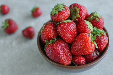 Fresh strawberries in bowl on table