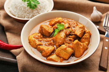 Tasty dinner with chicken curry in plate on tray