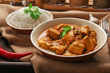 Tasty dinner with chicken curry in plate on tray