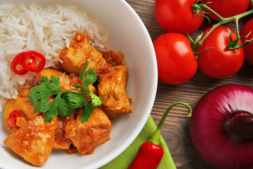 Tasty dinner with chicken curry and rice in plate