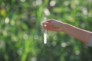Woman with test tube for expertise. Environmental pollution concept