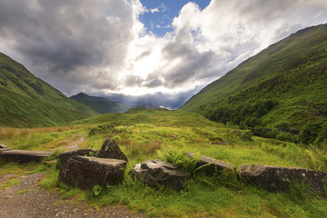 Fototapeta na wymiar Green and lush glen in Scotland highlands after rain