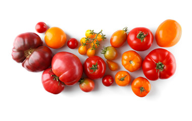 Composition of red and yellow tomatoes on white background