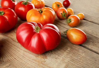 Composition of red and yellow tomatoes on wooden background