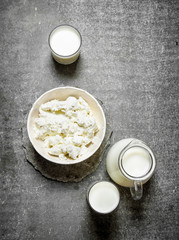 The cottage cheese in a bowl and milk.