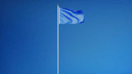 Fototapeta premium Light blue flag waving against clean blue sky, long shot, isolated with clipping mask alpha channel transparency, perfect for film, news, digital composition