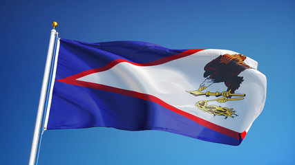 American Samoa flag waving against clean blue sky, close up, isolated with clipping mask alpha...