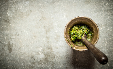 Pesto in a mortar with pestle.