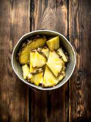 Slices of pineapple in a pot.