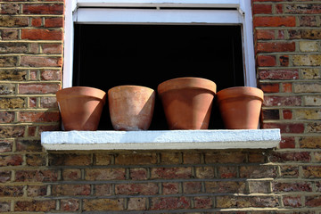 Window with empty plant pots.